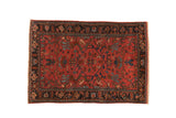 Antique Lilihan rug with a hexagonal shadow medallion over a raspberry red field and a dark floral border.