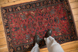 Antique Lilihan rug with a raspberry red field viewed from above to show scale.