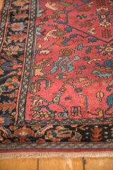 Close view of a Lilihan rug's corner showing floral borders and time-softened raspberry pile.