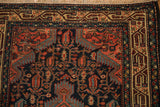 Corner spandrel and geometric borders with finned leaves on a vintage Persian Tajabad rug.