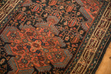 Corner detail of a vintage Tajabad rug showing the blush spandrel, navy field, and boteh motifs.