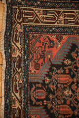 Detailed corner of the vintage Tajabad rug showing its geometric borders and secured side cord.