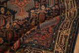 A soft fold reveals the hand-knotted boteh and vinery design of the vintage Persian Tajabad rug.