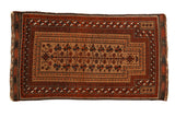 Antique Belouch prayer rug with a central field of stylized plants in sand, madder red, and deep charcoal.