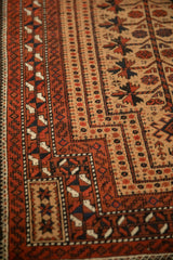 Detail of the low pile showing the knot heads and serpent design border on this antique Belouch rug.