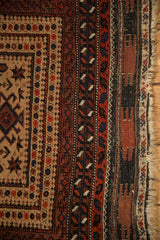 Worn selvage and serpent motif borders of a hand-knotted antique Belouch rug.