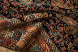 Colorful crab stylized main border and intricate botehs on a hand-knotted Persian wool pile.