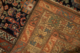 The hand-knotted foundation and dense navy pile of an antique Hamadan rug.