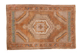 Vintage distressed Oushak rug with a stepped geometric medallion in coffee brown, beige, and dusty turquoise.