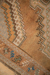 Detailed view of a vintage Oushak rug's worn pile and stepped corner designs in earthy hues.