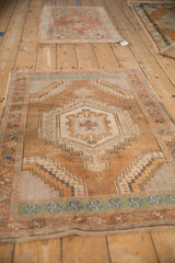 A vintage distressed Oushak rug with a stepped medallion, captured from a low, angled perspective.
