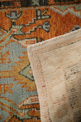 Corner view of a vintage Oushak runner showing its hand-knotted pile and woven foundation.