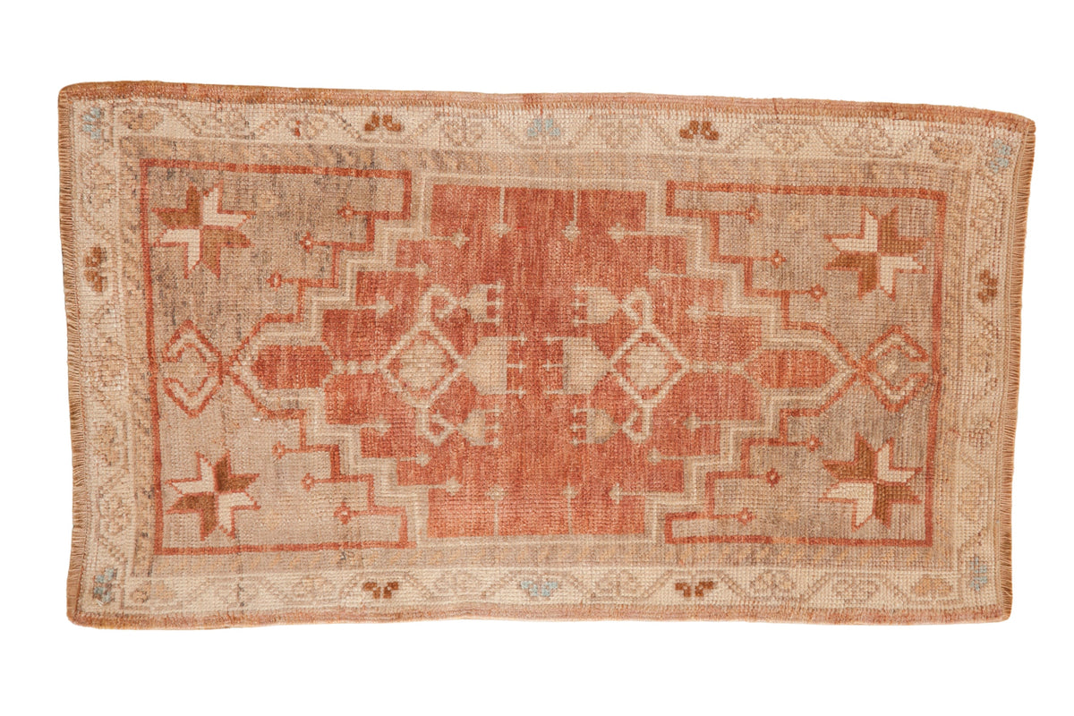 Distressed vintage Oushak rug runner featuring a stepped medallion in dusty plum and neutral tones.