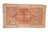 Distressed vintage Oushak rug runner featuring a stepped medallion in dusty plum and neutral tones.
