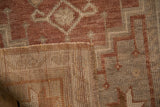 Distressed Oushak rug pile with sandalwood and beige geometric pattern, woven reverse, intact selvage.