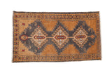 Vintage distressed Oushak rug with three charcoal medallions on a pale bronze field with red accents.