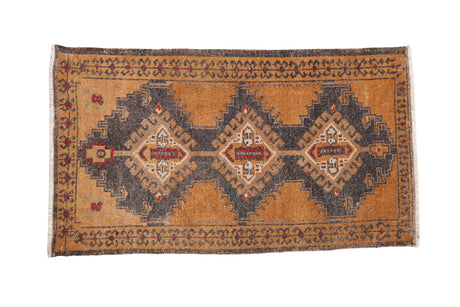 Vintage distressed Oushak rug with three charcoal medallions on a pale bronze field with red accents.