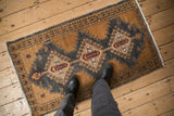 Overhead view of a distressed vintage Oushak runner showing its scale and texture underfoot.