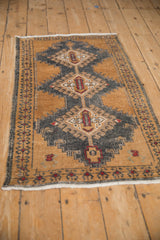 Full length angled view of a vintage Oushak runner with a central row of medallions.