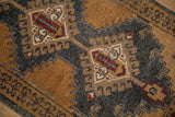 Close-up of the even wear and hook-and-latch medallion on a distressed vintage Oushak rug.