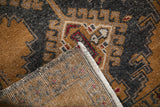 Corner detail of a vintage Oushak rug showing the hand-knotted foundation and low-pile front.