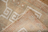 Vintage distressed Oushak rug's worn pile, secured selvage, and woven foundation.