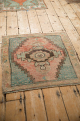 Detail of distressed vintage Oushak rug with serrated medallion, abrashed cantaloupe and denim blue field.