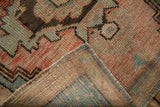 Vintage distressed Oushak rug corner, showing hand-knotted pile texture and woven foundation.
