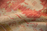 Close-up showing the mostly even wear and visible knot heads of a distressed vintage Oushak rug.