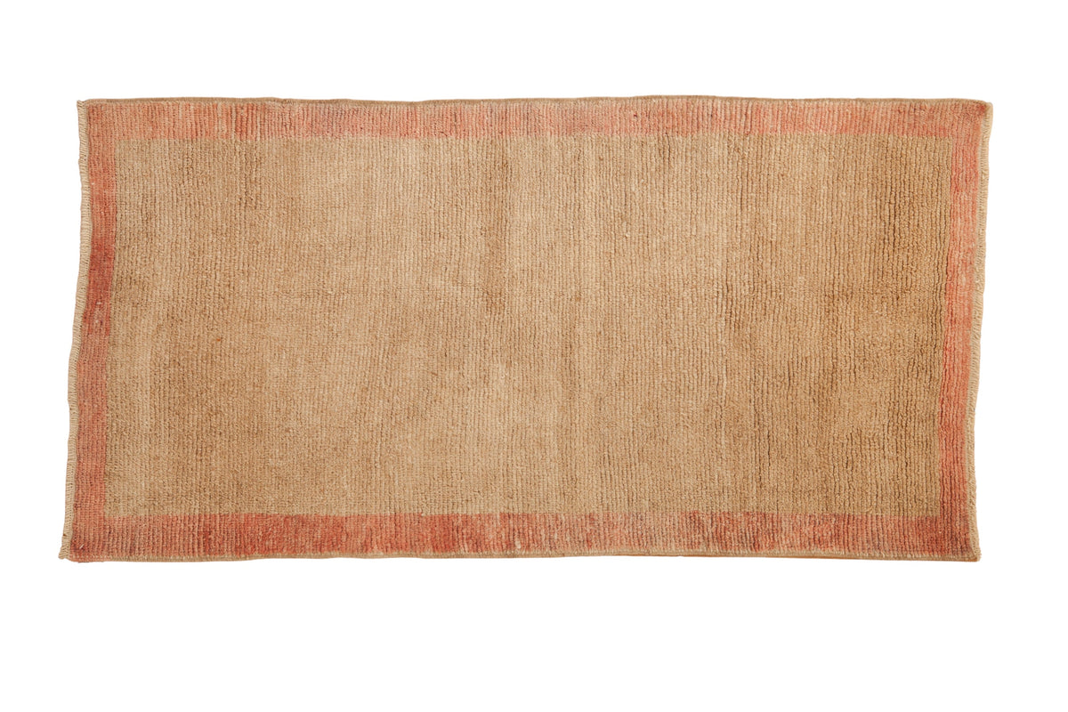 Distressed vintage Tulu rug runner with soft beige field and pale red border, 2'9" x 5'5".