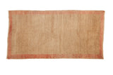 Distressed vintage Tulu rug runner with soft beige field and pale red border, 2'9