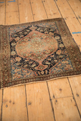 Angled perspective of a circa 1920s Sarouk rug, showing its low pile and intricate medallion design.