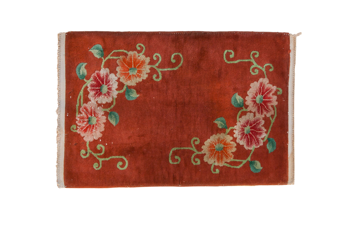 Vintage Art Deco rug mat with opposing floral bouquets and green vines on a copper-red field.