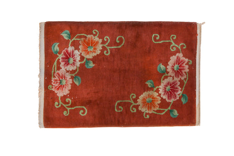 Vintage Art Deco rug mat with opposing floral bouquets and green vines on a copper-red field.