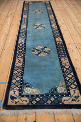 Angled perspective of a vintage Peking runner, highlighting its sky blue field and repeating medallions.