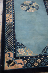 Angled view of the Peking runner's corner, highlighting the cobalt and pale rose borders and sky blue field.