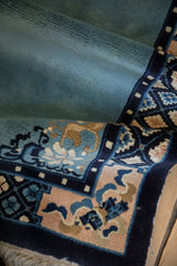 Soft texture of the hand-knotted short pile on a vintage Peking rug with a curvilinear border.
