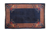 Vintage Art Deco rug featuring a cobalt blue field and wide blush border with delicate floral sprays.