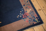 Delicate floral sprays on slender vines at the corner of a vintage Chinese Art Deco rug.