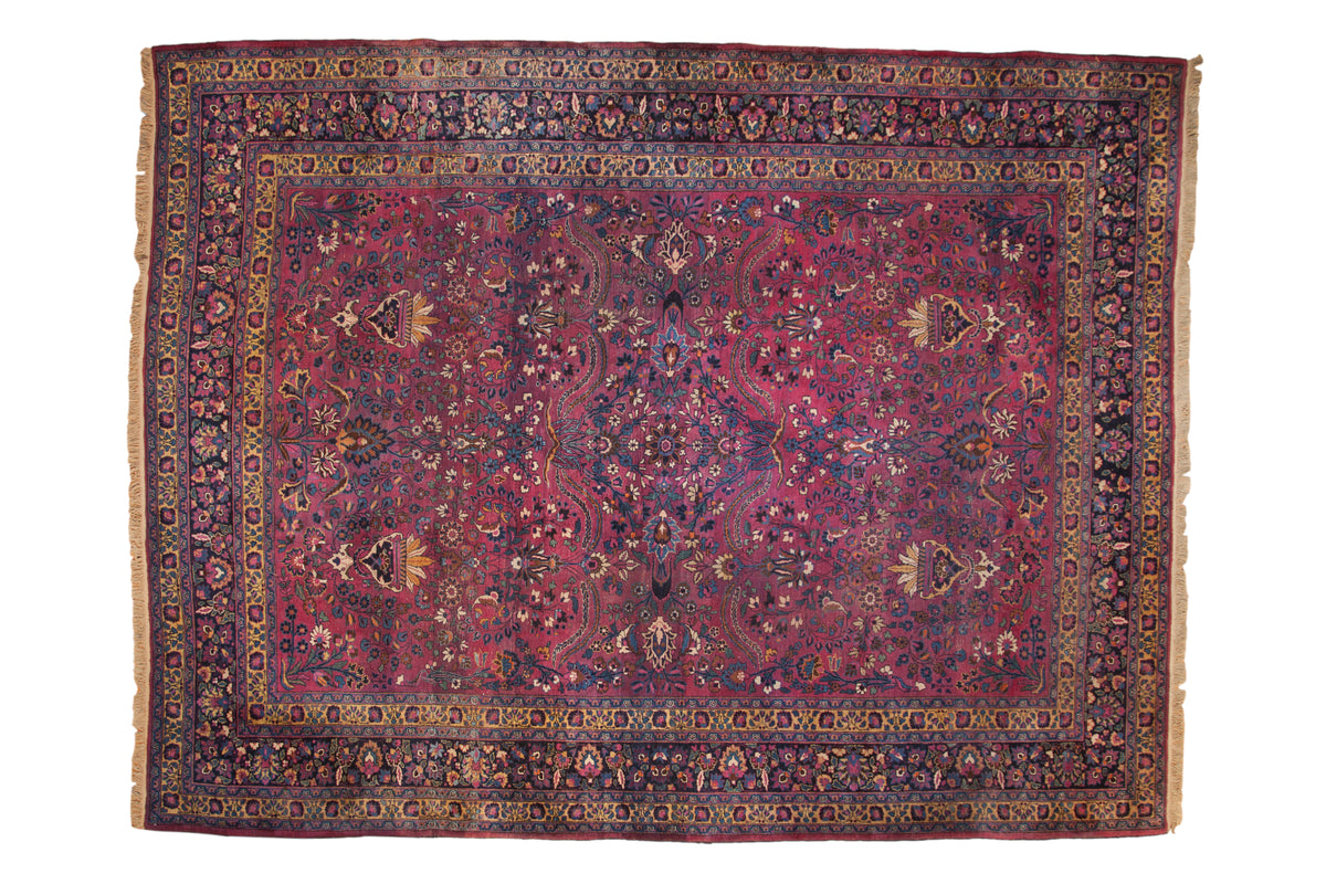 Vintage Persian Meshed carpet with allover scrolling vines and planters on an aubergine purple field.