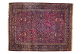 Vintage Persian Meshed carpet with allover scrolling vines and planters on an aubergine purple field.