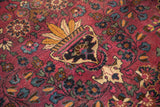 Detailed planter motif with saffron leaves and scrolling vines on a vintage Persian Meshed carpet.