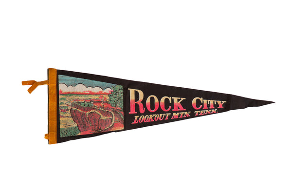 Vintage Rock City felt flag pennant showing a colorful Lookout Mountain scene on a black background.