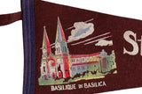 Close-up of the colorful basilica graphic on the dark maroon vintage felt pennant.