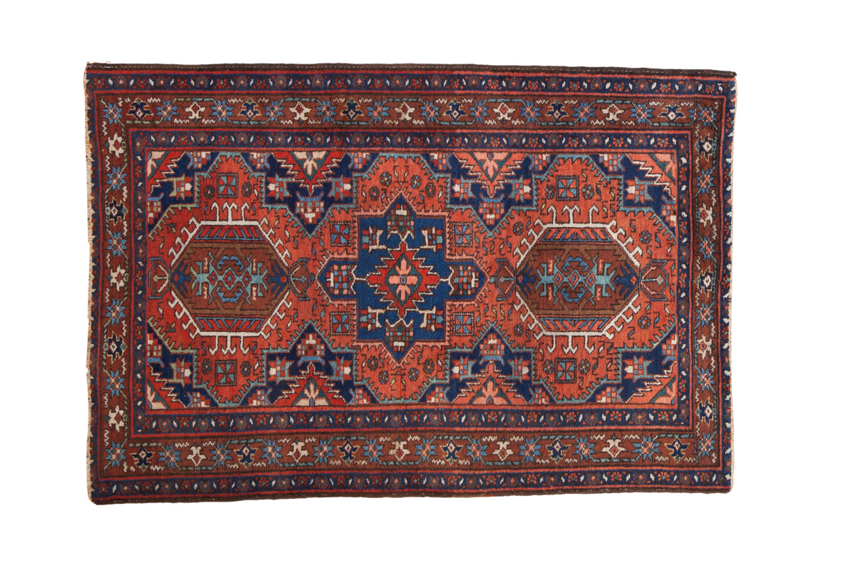 Vintage Karaja rug with a geometric triple medallion design in madder red, sapphire blue, and brown tones.