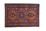 Vintage Karaja rug with a geometric triple medallion design in madder red, sapphire blue, and brown tones.