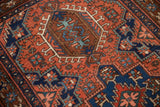 Close detail of the rectilinear hook and latch motif on a vintage Persian Karaja rug's short pile.