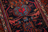 Vintage Kurdish Hamadan rug detail: navy blue field with red geometric serrated floral motifs.