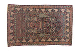 Antique Tehran rug with a unidirectional tree-of-life design, navy field, and symbolic pomegranate borders.