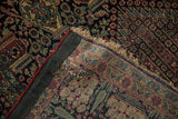 Reverse side of a collector's Persian rug showing hand-knotted construction and period repairs.